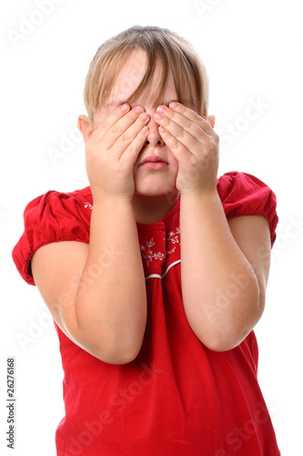 Small girl holding her eyes with her hands so that she can't see