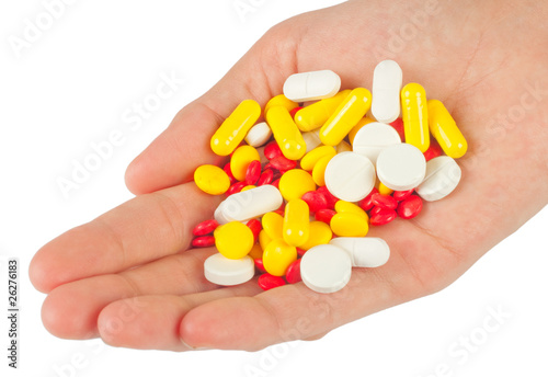 Pills in a hand on white background