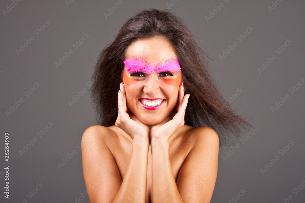 Portrait of an attractive smiling woman touching her cheeks Portrait of an attractive smiling woman touching her cheeks