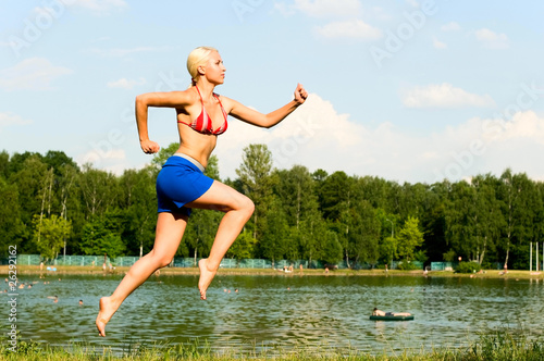 girl running near the pond
