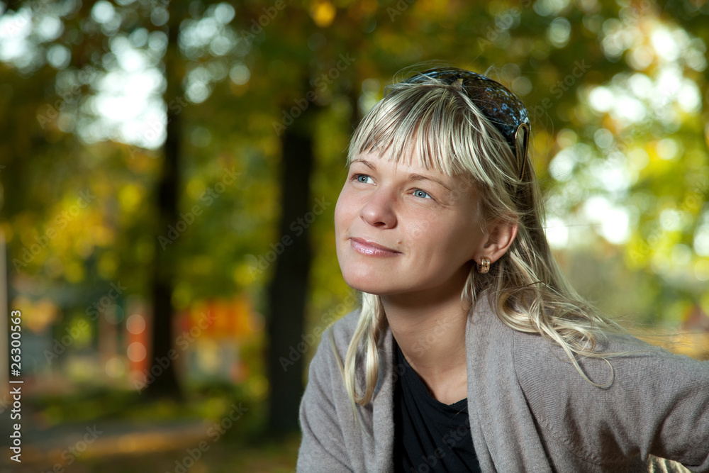 Blond woman with sunglasses portrait in a autumn park. Blond woman with sunglasses portrait in a autumn park.