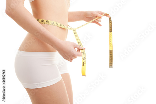 Athletic woman with measure tape