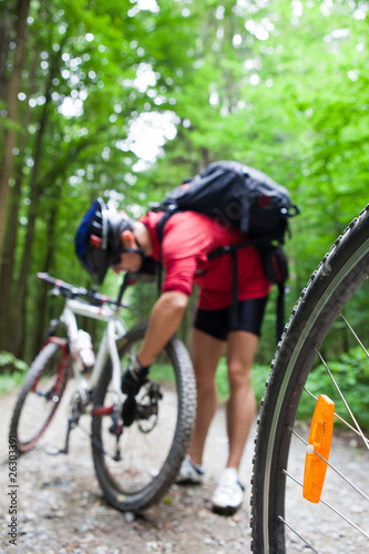Mountain biking in a forest - bikers on a forest biking trail (s