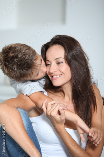 Little boy kissing her mom