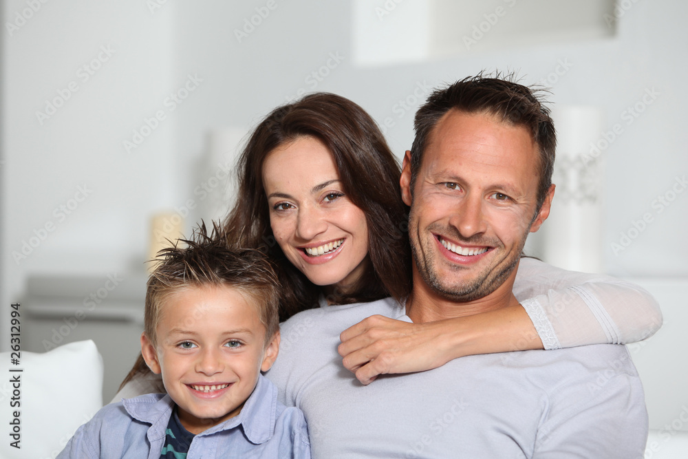 Closeup of parents and child relaxing at home on sofa Closeup of parents and child relaxing at home on sofa