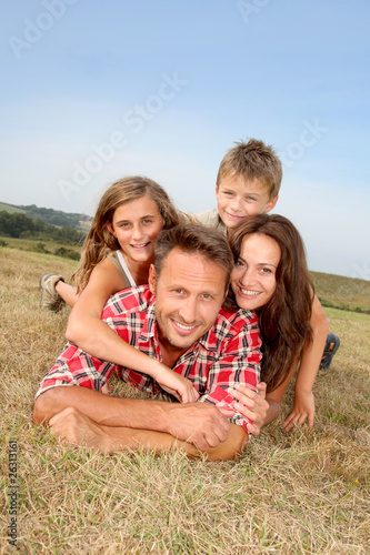 Closeup of happy family lying in grass