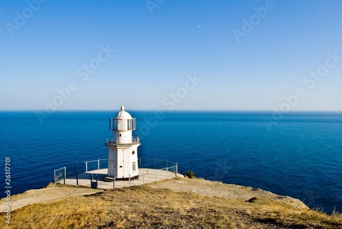 beautiful white lighthouse on a meganom krimea ukraine photo