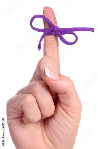 A finger contains a bow-tied string as a reminder