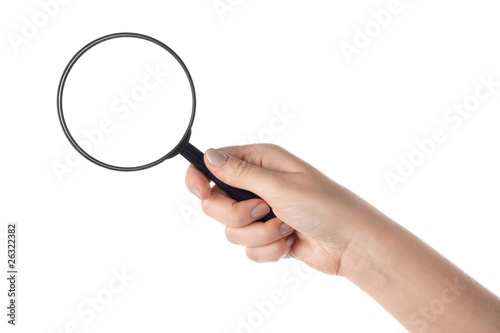 Female hand holding the magnifying glass (isolated)