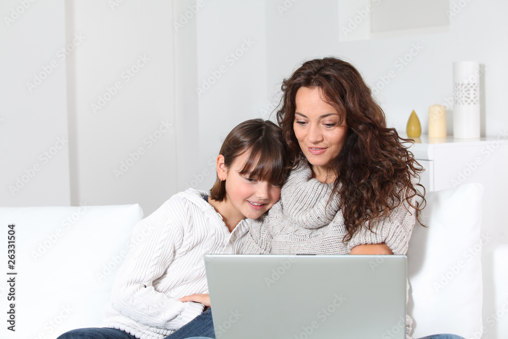 Closeup of mother and child at home with laptop computer Closeup of mother and child at home with laptop computer