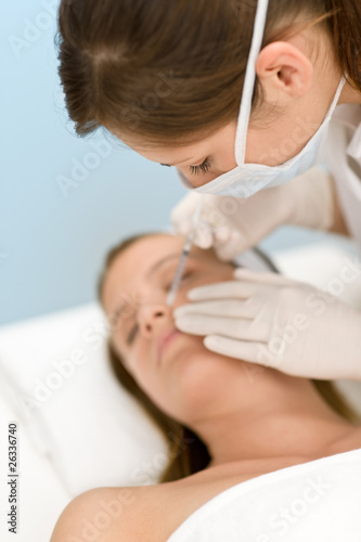 Botox injection - woman in cosmetic medicine treatment