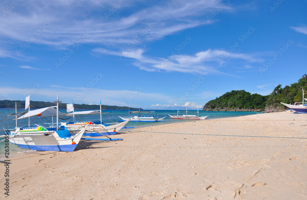 traditional paraw sailing boat on white beach