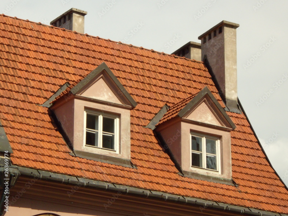 Tile roof, two dormers and white chimneys