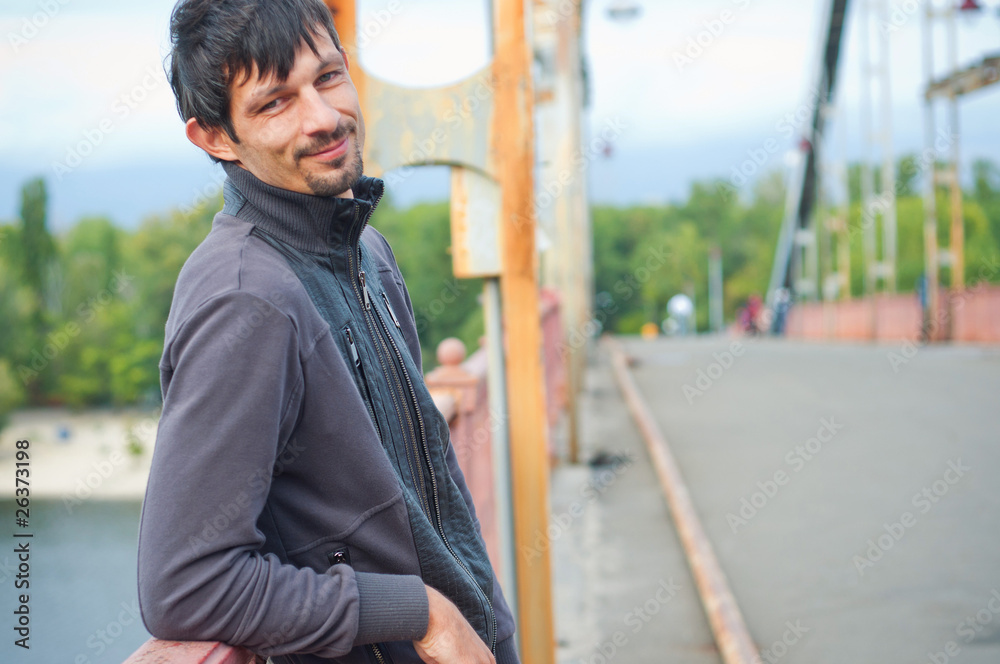 Obraz premium Portrait of a young beautiful man on autumn walk