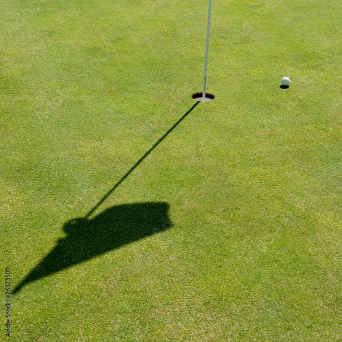 Golf hole, flag and ball