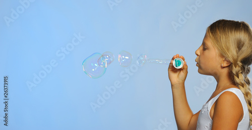 The pretty girl with soap bubbles