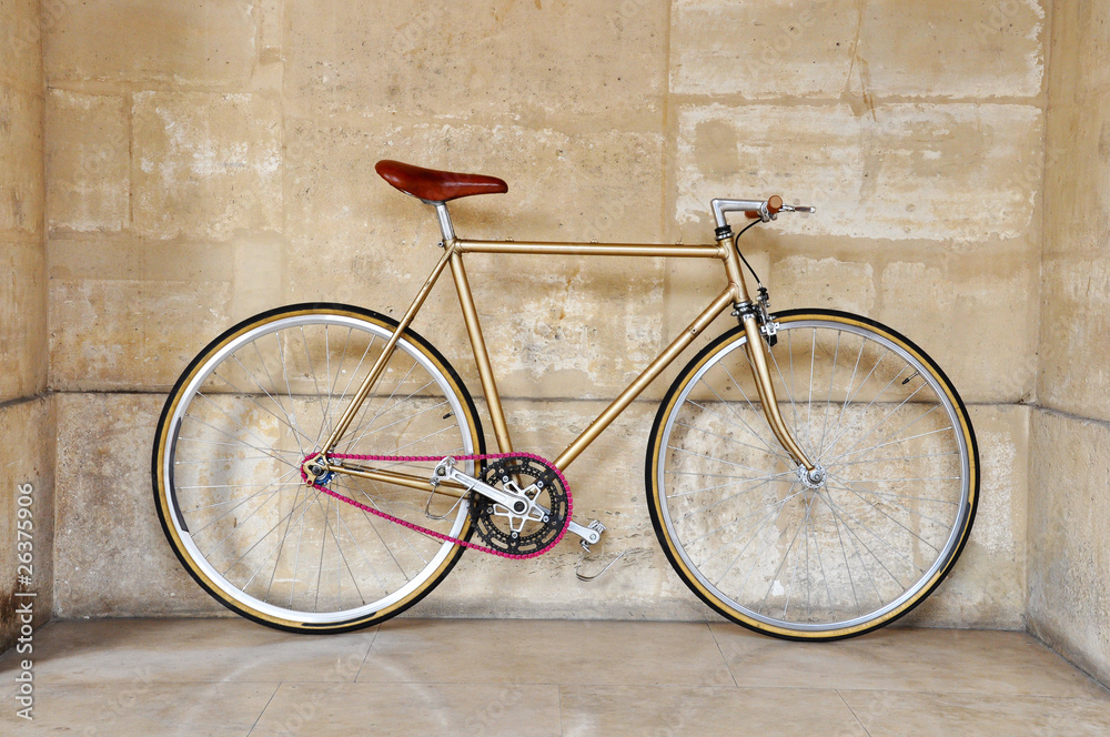 A fixed-gear bicycle with a pink chain