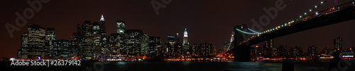 Panoramic New York City skyline from the Brooklyn at night. © trappy76