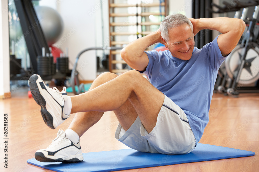 Senior Man Doing Sit Ups In Gym Senior Man Doing Sit Ups In Gym