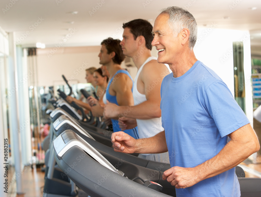 Senior Man On Running Machine In Gym Senior Man On Running Machine In Gym