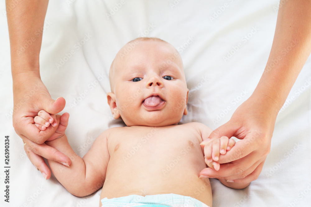 The parent holds for hands of the baby The parent holds for hands of the baby