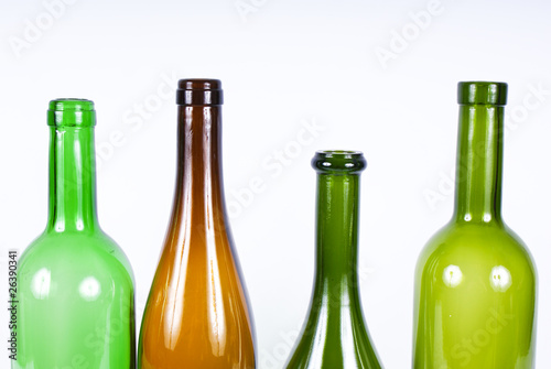 Four colored bottles on a white background.