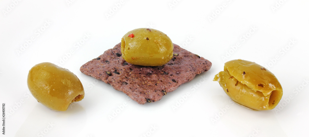 Green pitted olives on rice cracker Green pitted olives on rice cracker