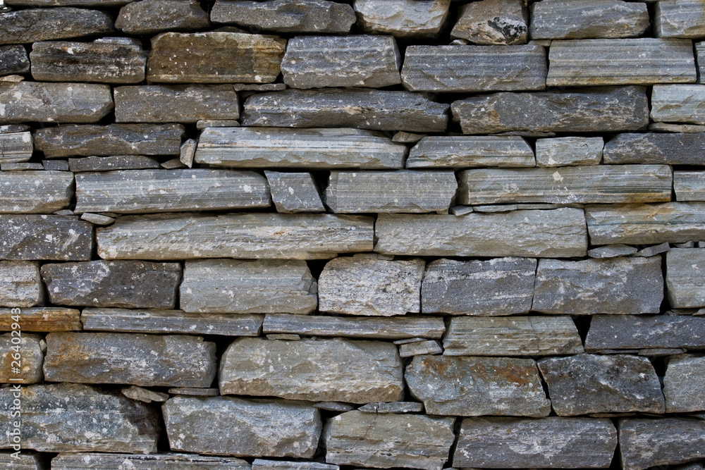Fototapeta premium A stone wall made of gray stone