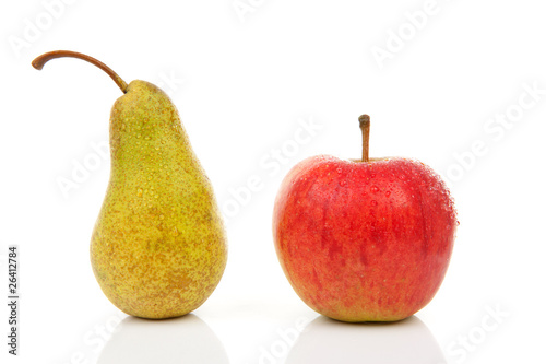 Juicy pear and red apple with water drops over white background