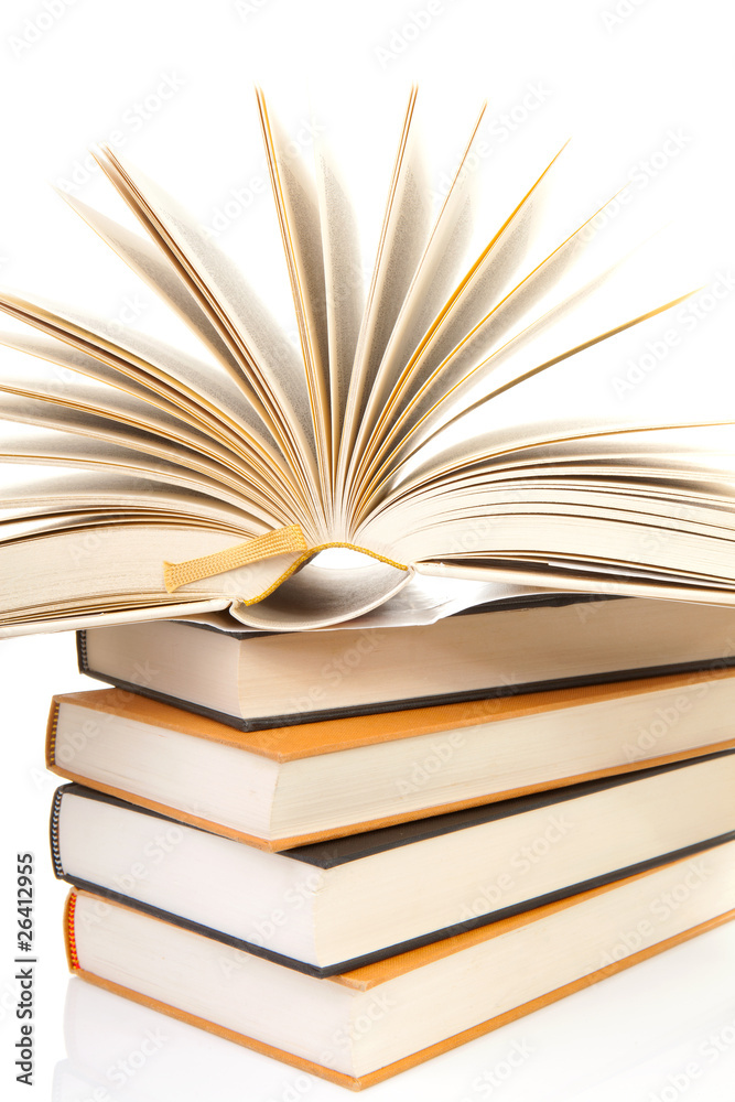 Fototapeta premium stack of books with open book over white background
