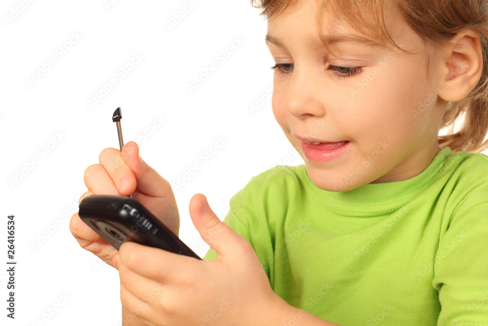 small girl in green blouse with interest studies new telephone small girl in green blouse with interest studies new telephone