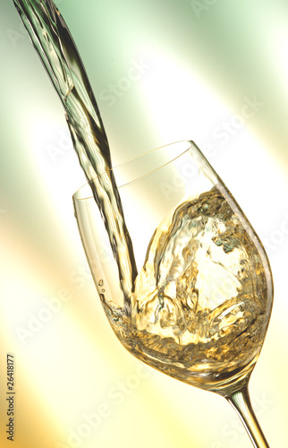Pour white vine into glass with light background.