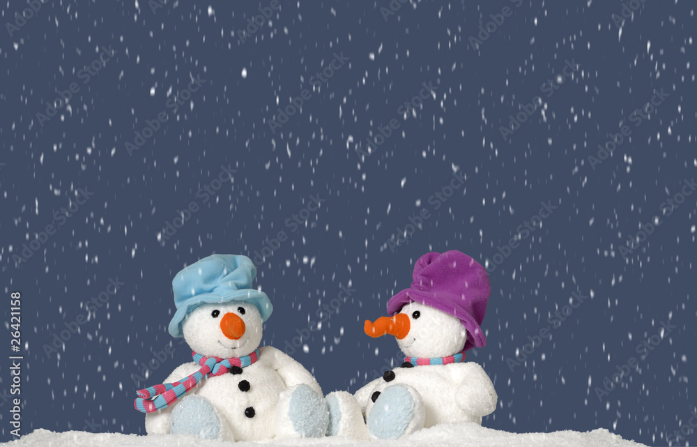 snowing on 2 snowmen sitting in the snow snowing on 2 snowmen sitting in the snow