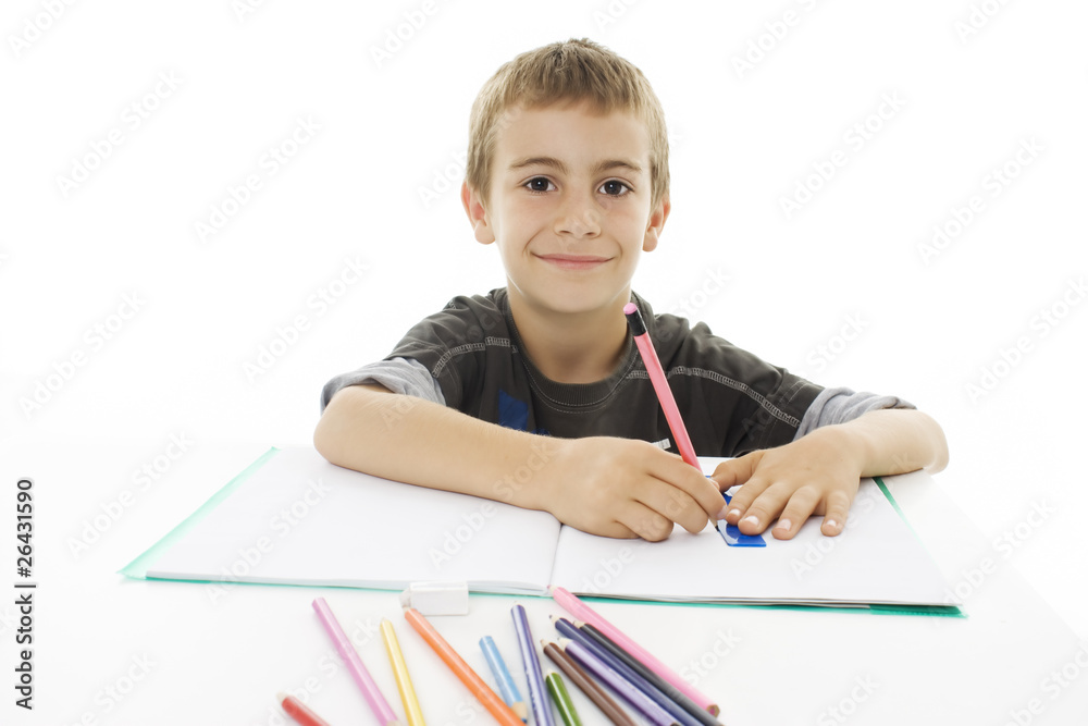 School boy sitting and writing in notebook. School boy sitting and writing in notebook.