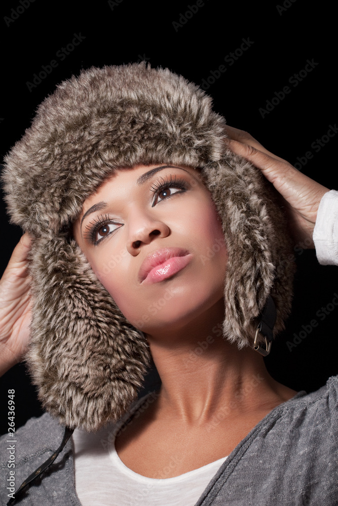 Beautiful happy young woman wearing a fur hat Beautiful happy young woman wearing a fur hat