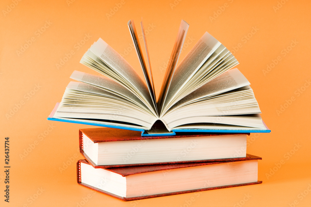 Fototapeta premium Stack of books on the color background