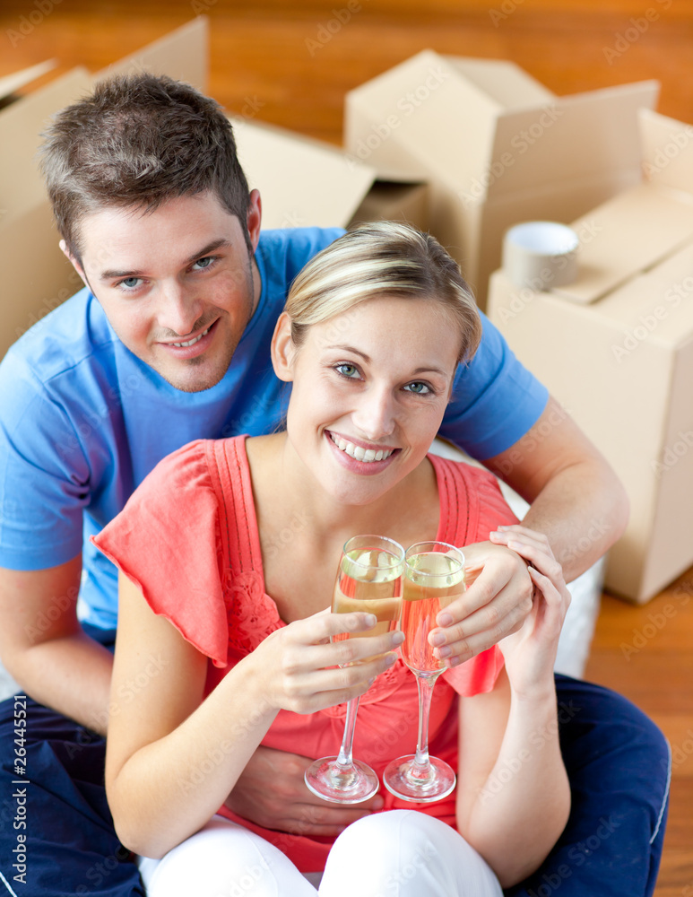 cheerful couple celebrating their new house with champagne cheerful couple celebrating their new house with champagne