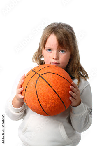 Small girl with long hair holding basketball isolated on white