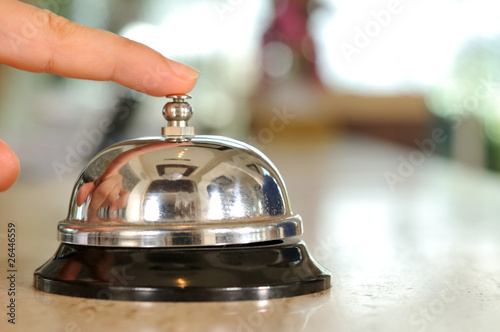 Hand of a woman using a hotel bell -a series of HOTEL images. photo