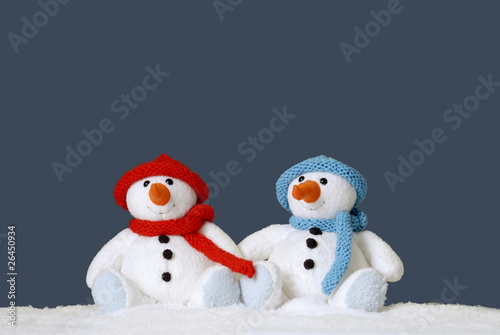 two cute snowmen sitting in the snow © aldegonde le compte