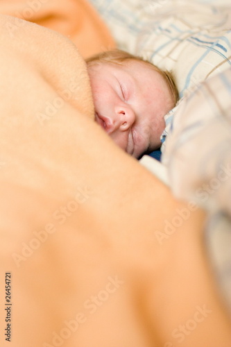 sleeping baby in big bed