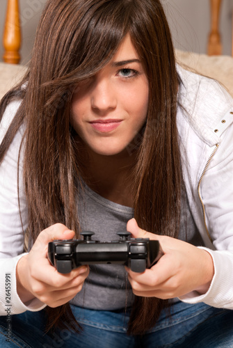 Young girl concentrating playing video-games close-up