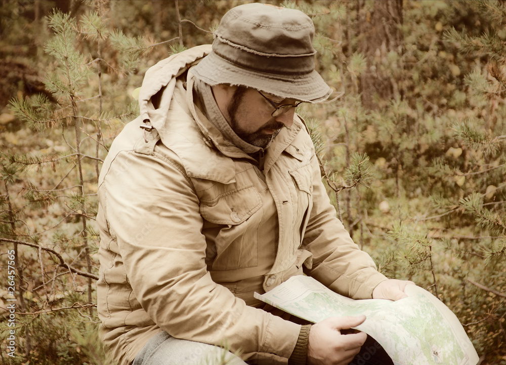Hiker with map in forest