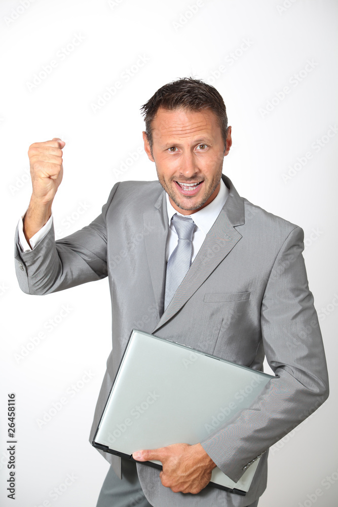 Businessman with laptop computer lifting arm up Businessman with laptop computer lifting arm up