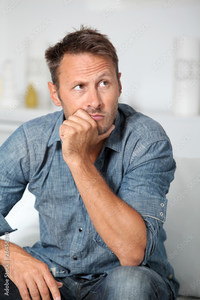Closeup of man sitting in sofa Closeup of man sitting in sofa