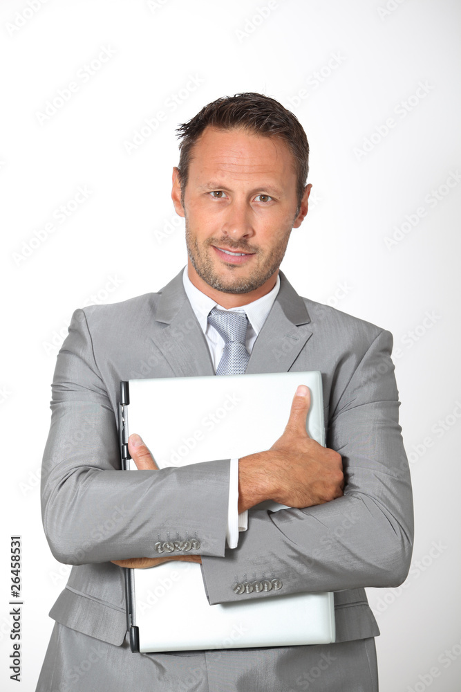 Businessman carrying laptop computer Businessman carrying laptop computer