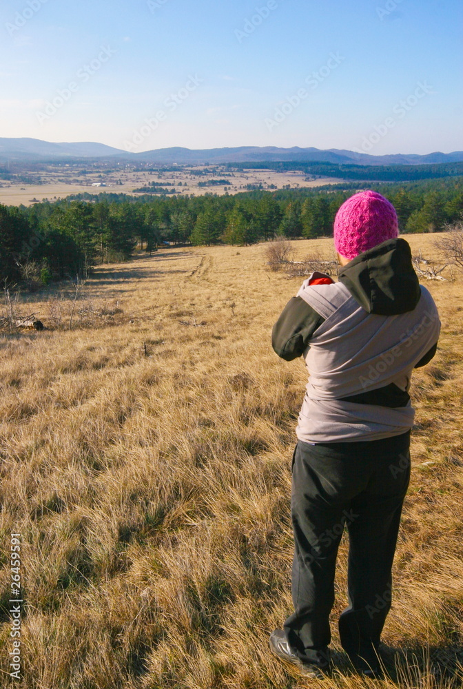 Young mother admiring the view on autumn walk with newborn Young mother admiring the view on autumn walk with newborn