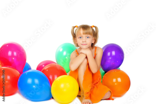 Cute little girl playing with baloons after party