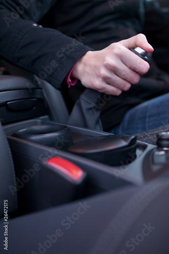 driving concept - young female driver using handbrake © lightpoet