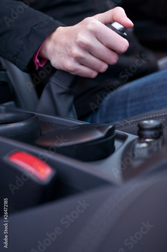 driving concept - young female driver using handbrake